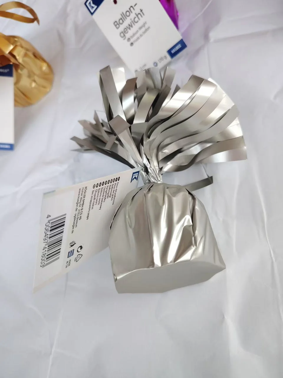 Silver 170g helium balloon weight with PET foil tassels and attachment loop